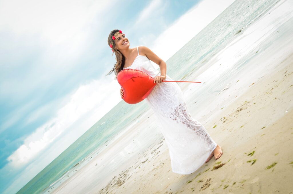 Smiling woman with heart-shaped balloon enjoying the summer beach vibe in Recife, Brazil.